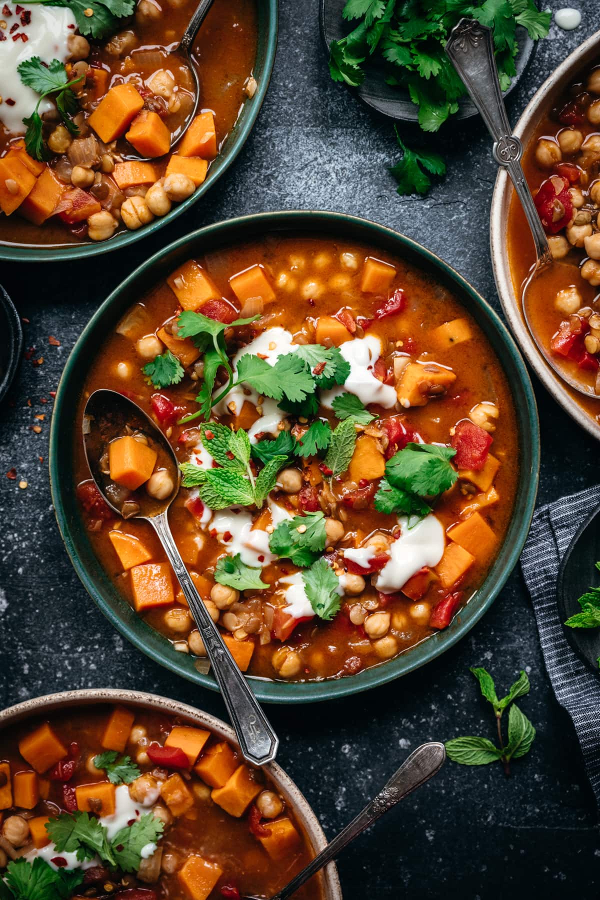 overhead view of vegan Moroccan chickpea lentil stew in bowl with spoon