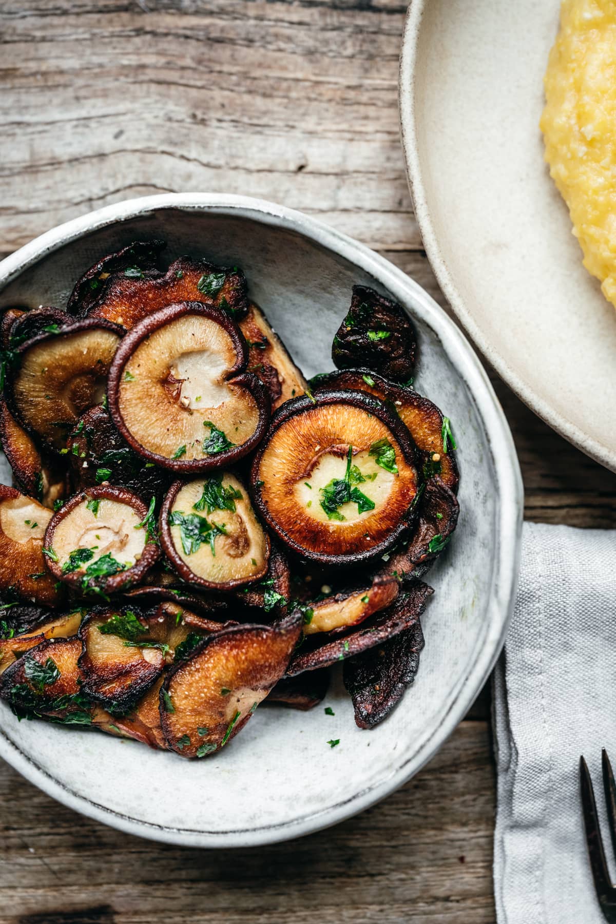 close up view of pan seared shiitake mushrooms in a bowl