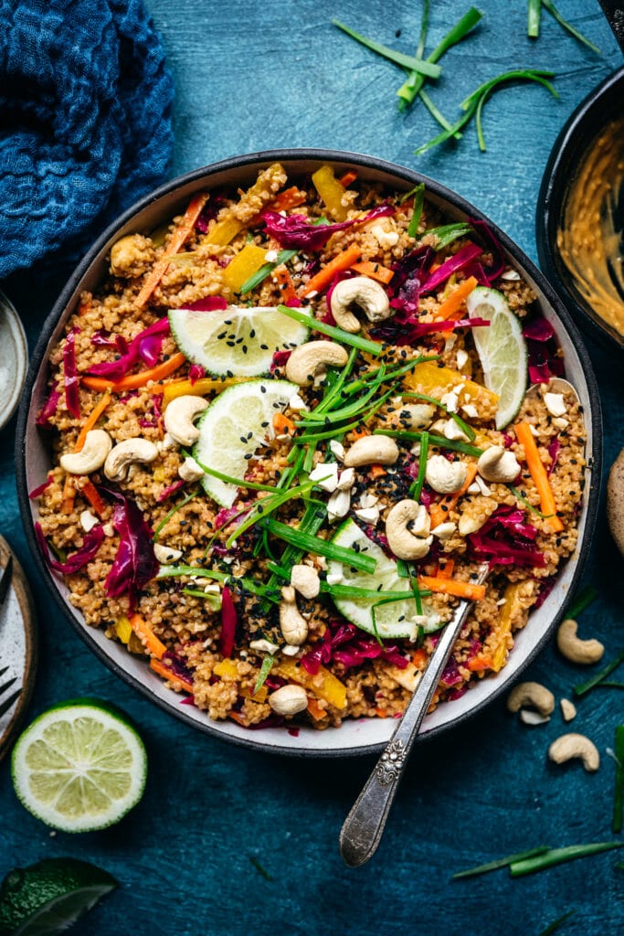 overhead view of thai quinoa salad with crunchy vegetables and peanut sauce