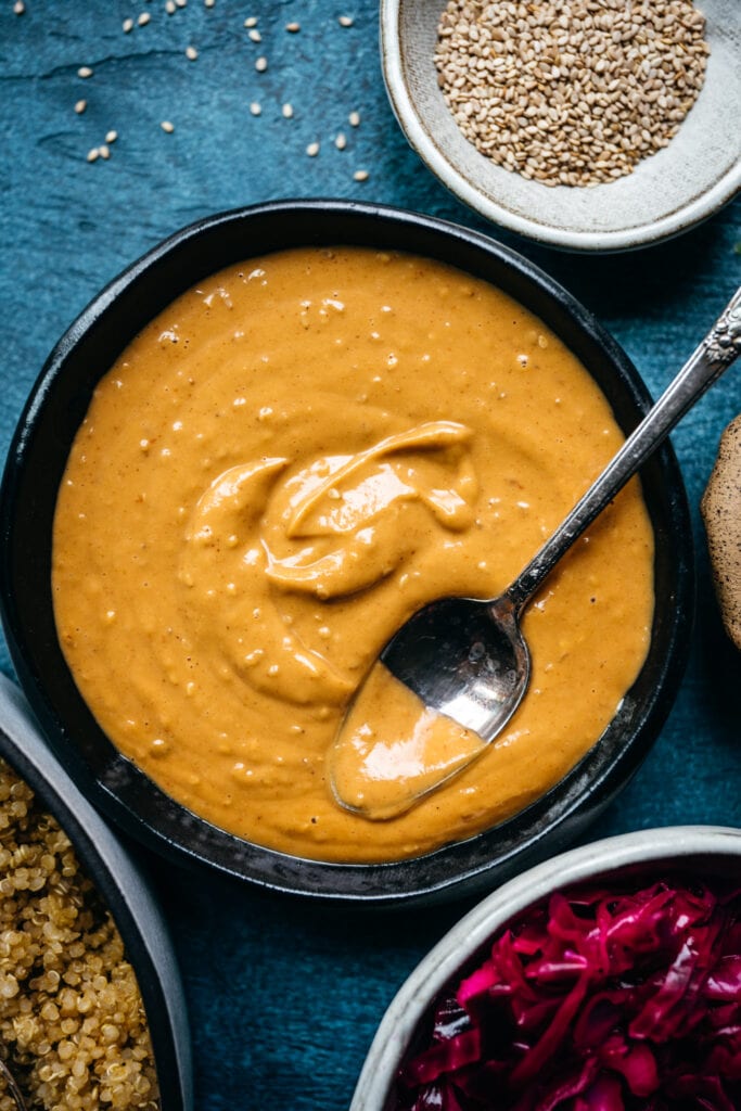 close up overhead view of creamy peanut sauce in bowl