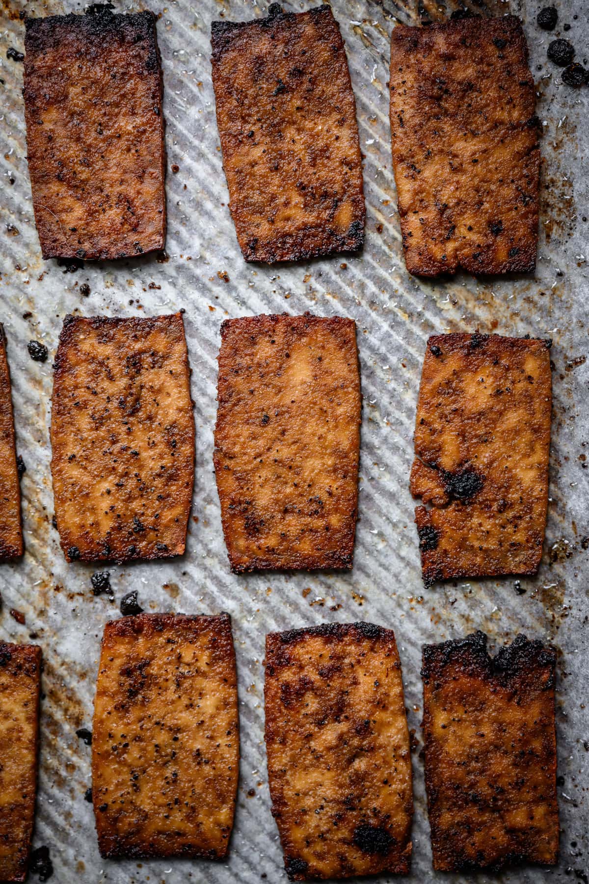 close up overhead view of vegan tofu bacon on sheet pan