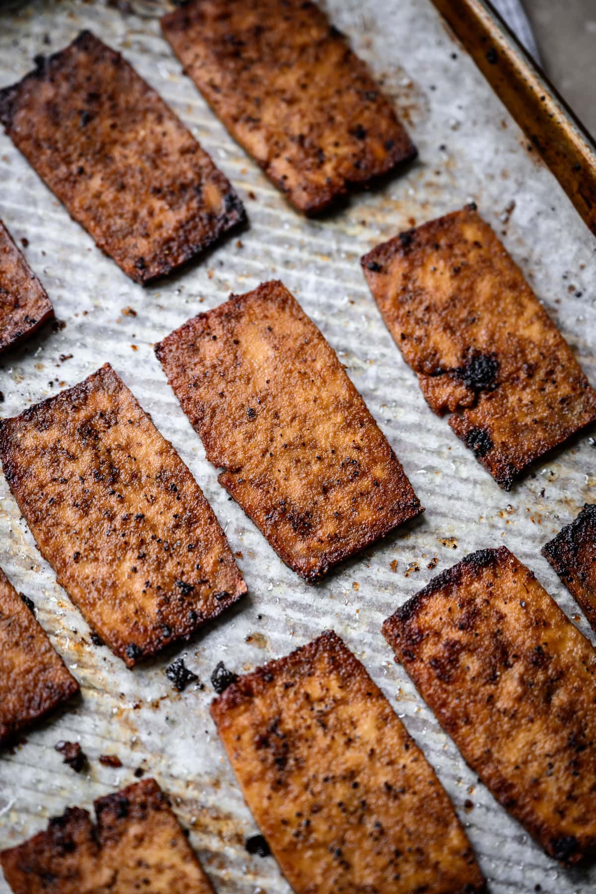 side view of vegan tofu bacon on sheet pan