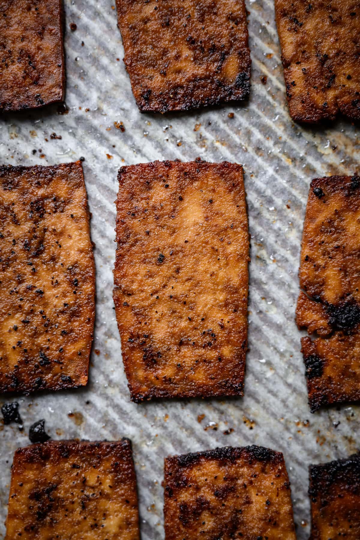 close up overhead view of vegan tofu bacon on sheet pan