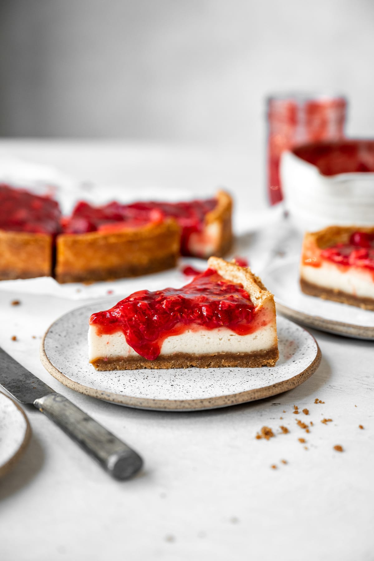 side view of a slice of baked vegan cheesecake on a plate