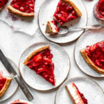 Slices of vegan cheesecake with strawberry topping seen from above.