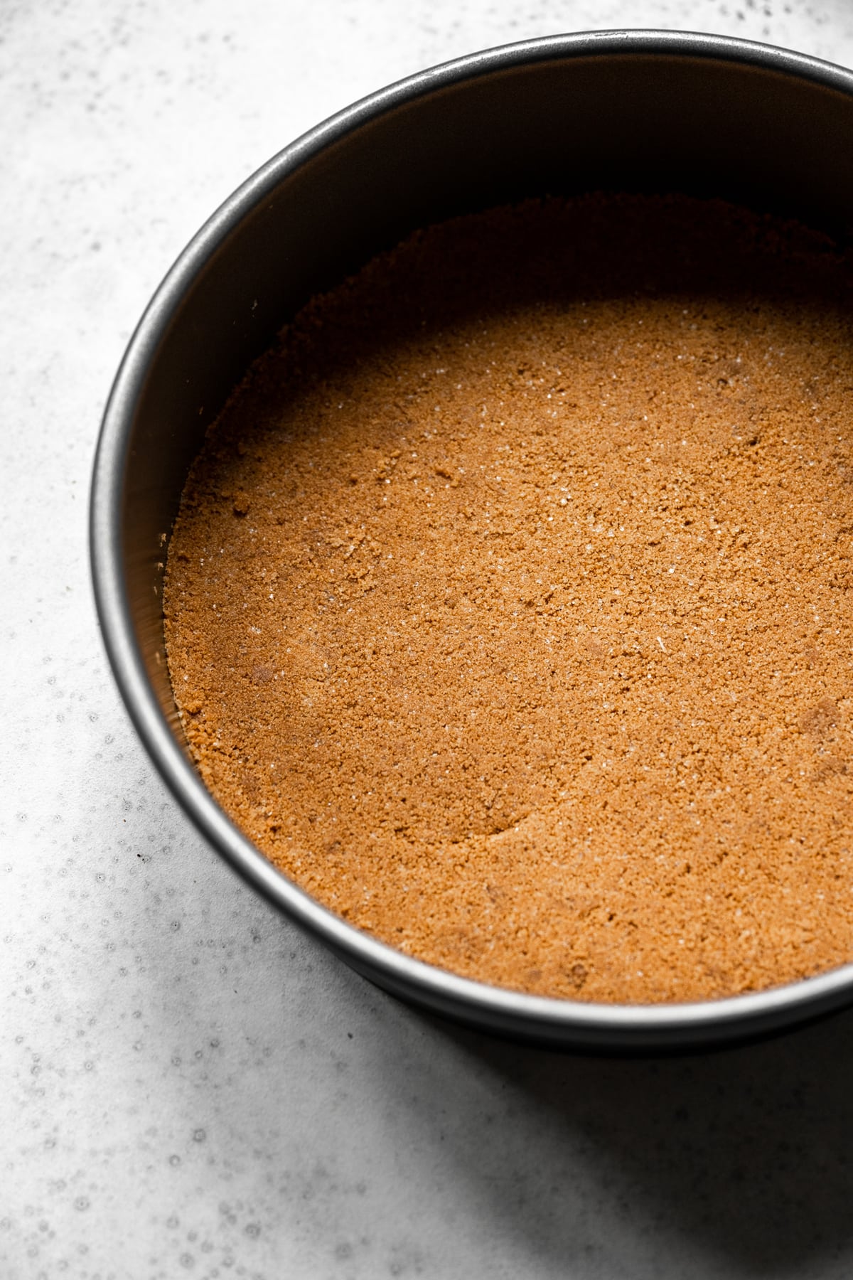 overhead view of graham cracker crust for cheesecake