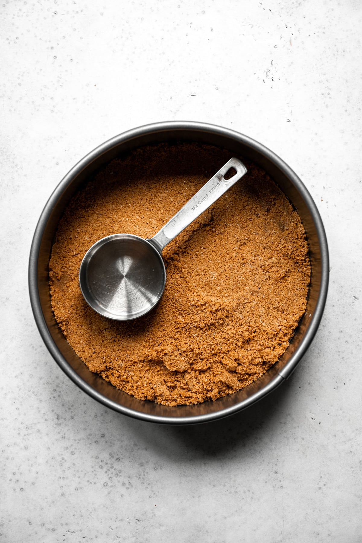 overhead view of graham cracker crust for cheesecake