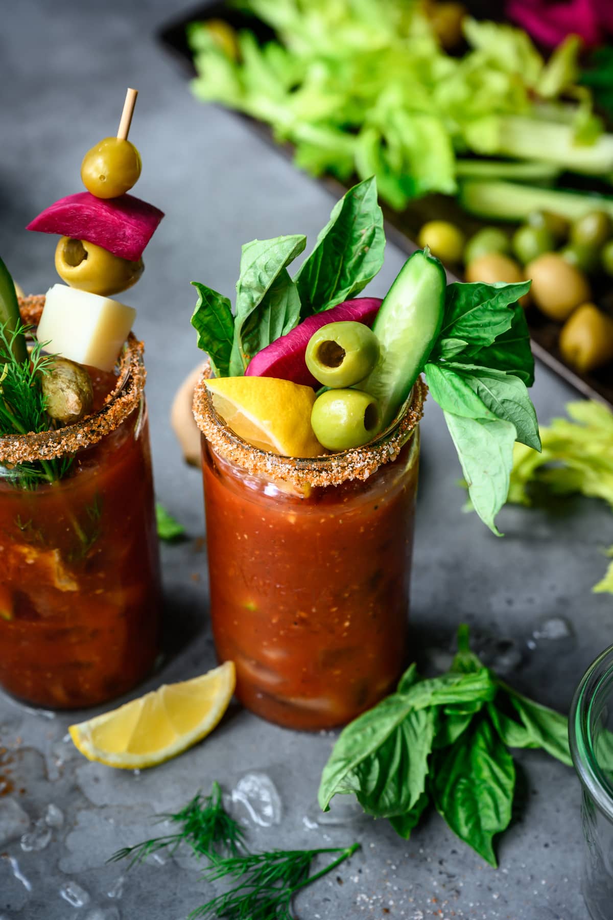side view of vegan bloody mary in tall glass with garnishes