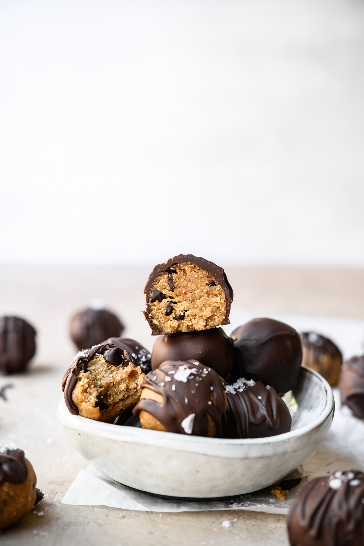 side view of bowl full of vegan gluten free cookie dough truffles