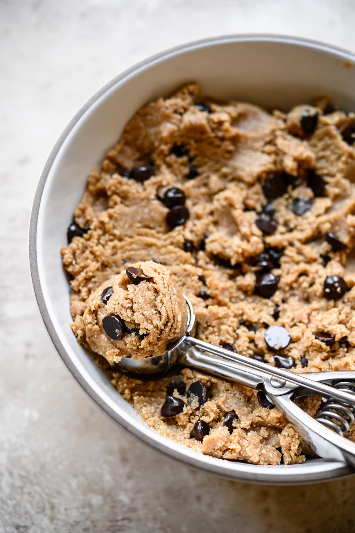 side view of edible vegan cookie dough in a bowl