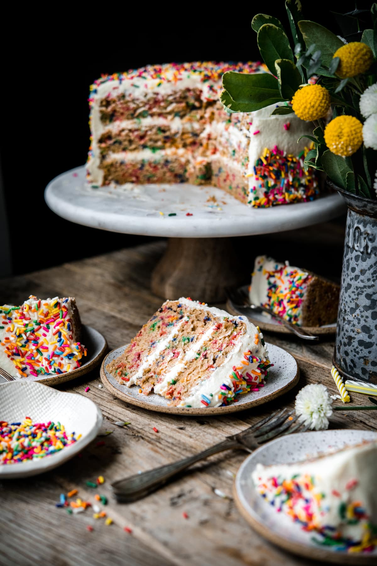 side view of slice of funfetti cake on small plates
