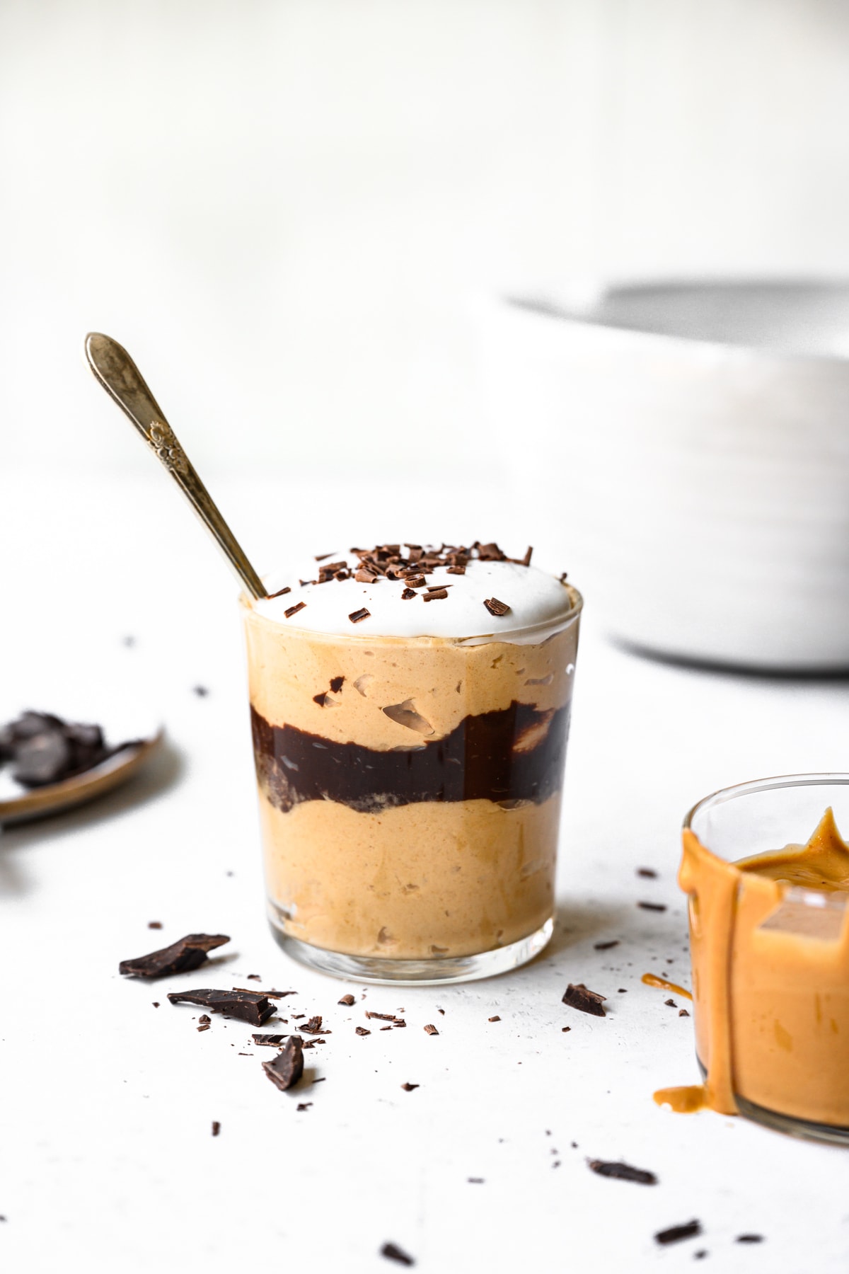 side view of vegan peanut butter chocolate mousse in a jar with spoon