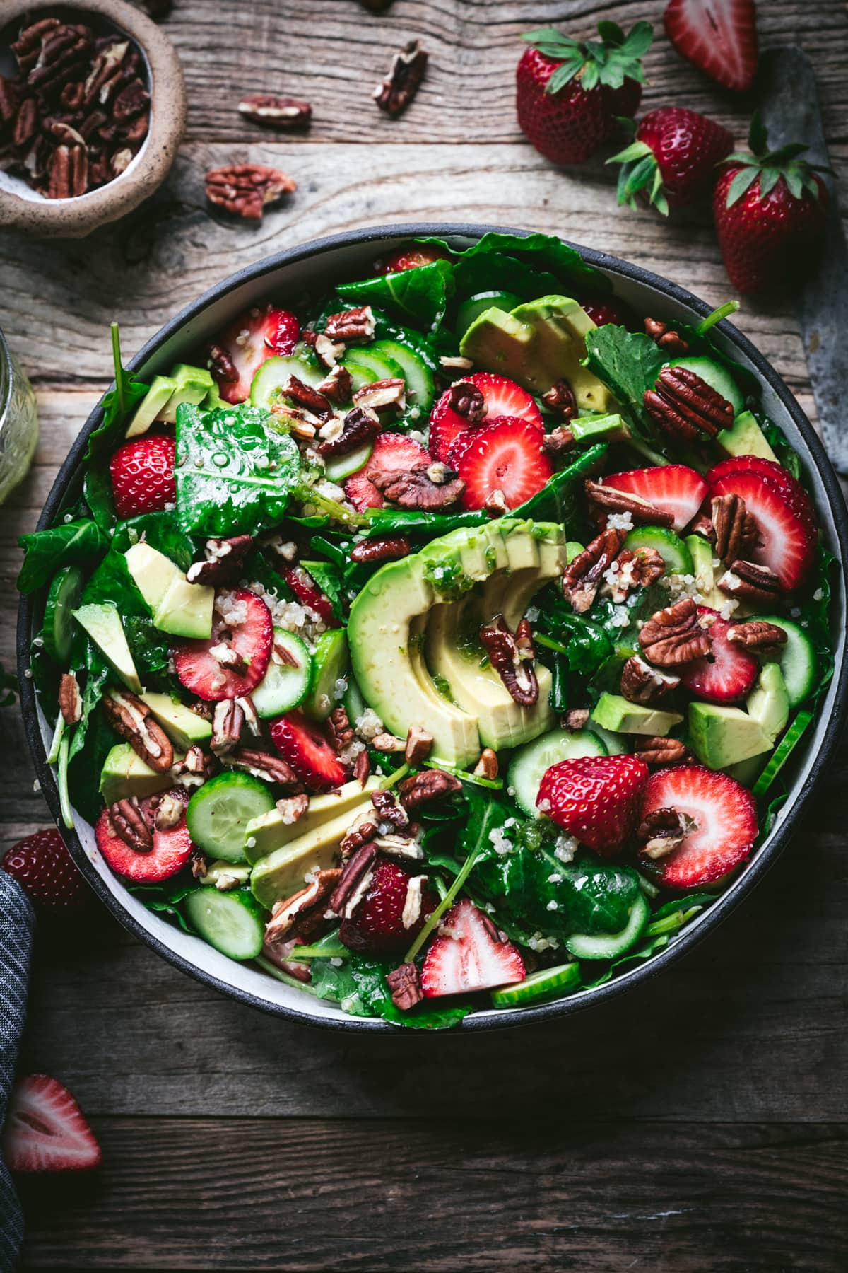 overhead view of strawberry quinoa avocado salad in white bowl