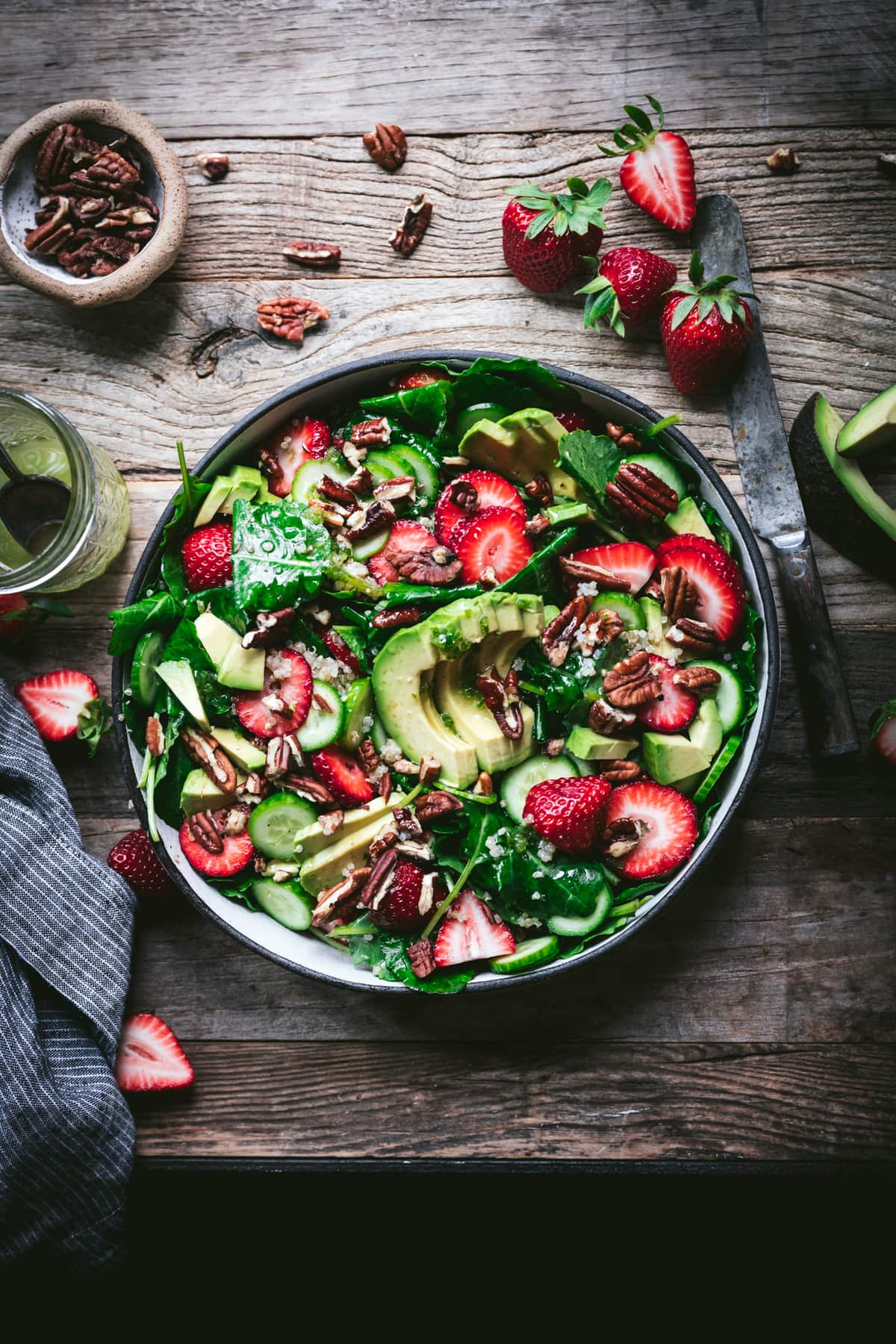 overhead view of strawberry avocado quinoa salad in a white salad bowl