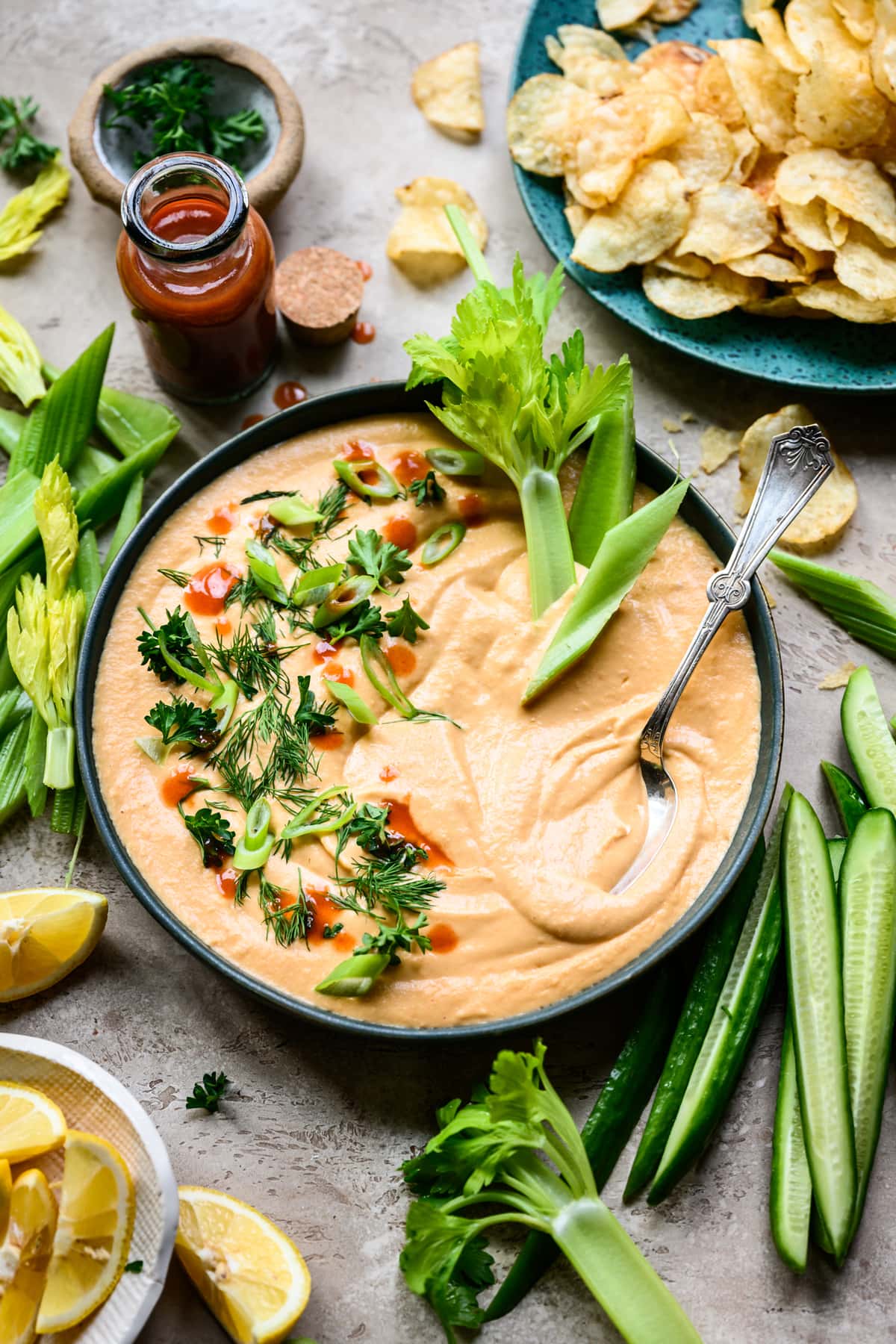 side view of buffalo white bean dip with celery for dipping