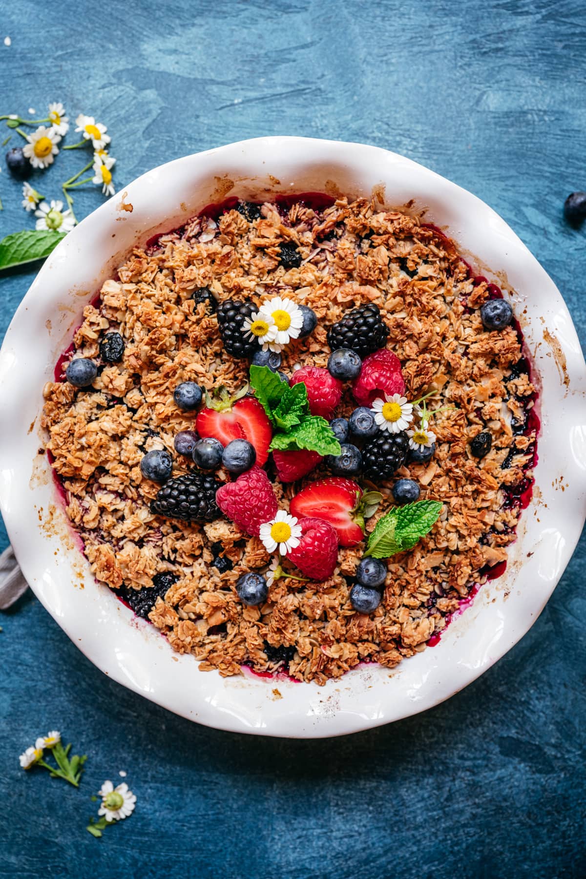 overhead view of vegan gluten free triple berry crisp with granola