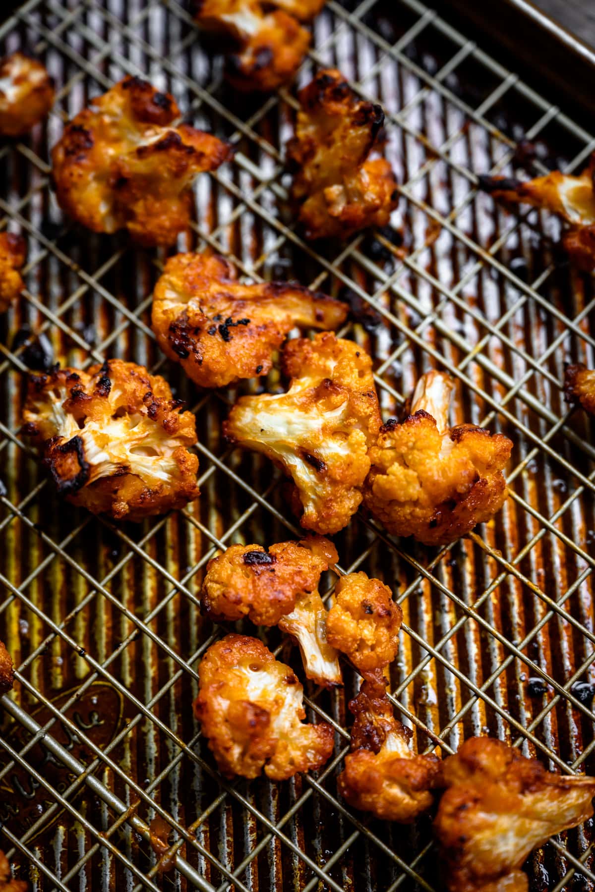 side view of roasted buffalo cauliflower on a sheet pan