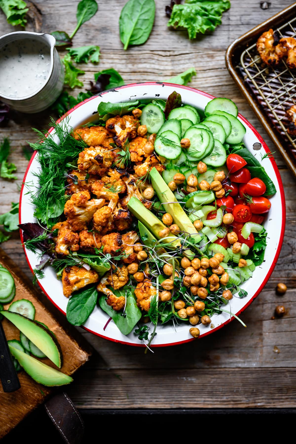 overhead view of vegan buffalo cauliflower salad with ranch and avocado