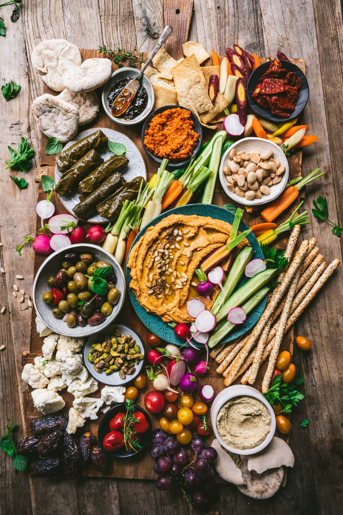 overhead view of Vegan Mezze Platter with hummus, dolma, nuts, vegetables and more