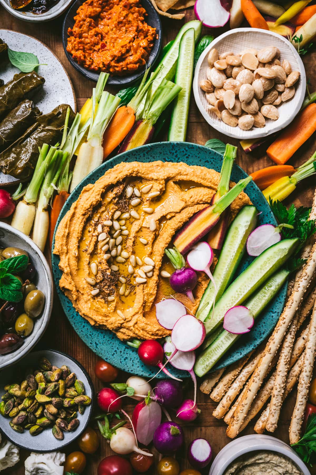 overhead view of Vegan Mezze Platter with hummus, dolma, nuts, vegetables and more