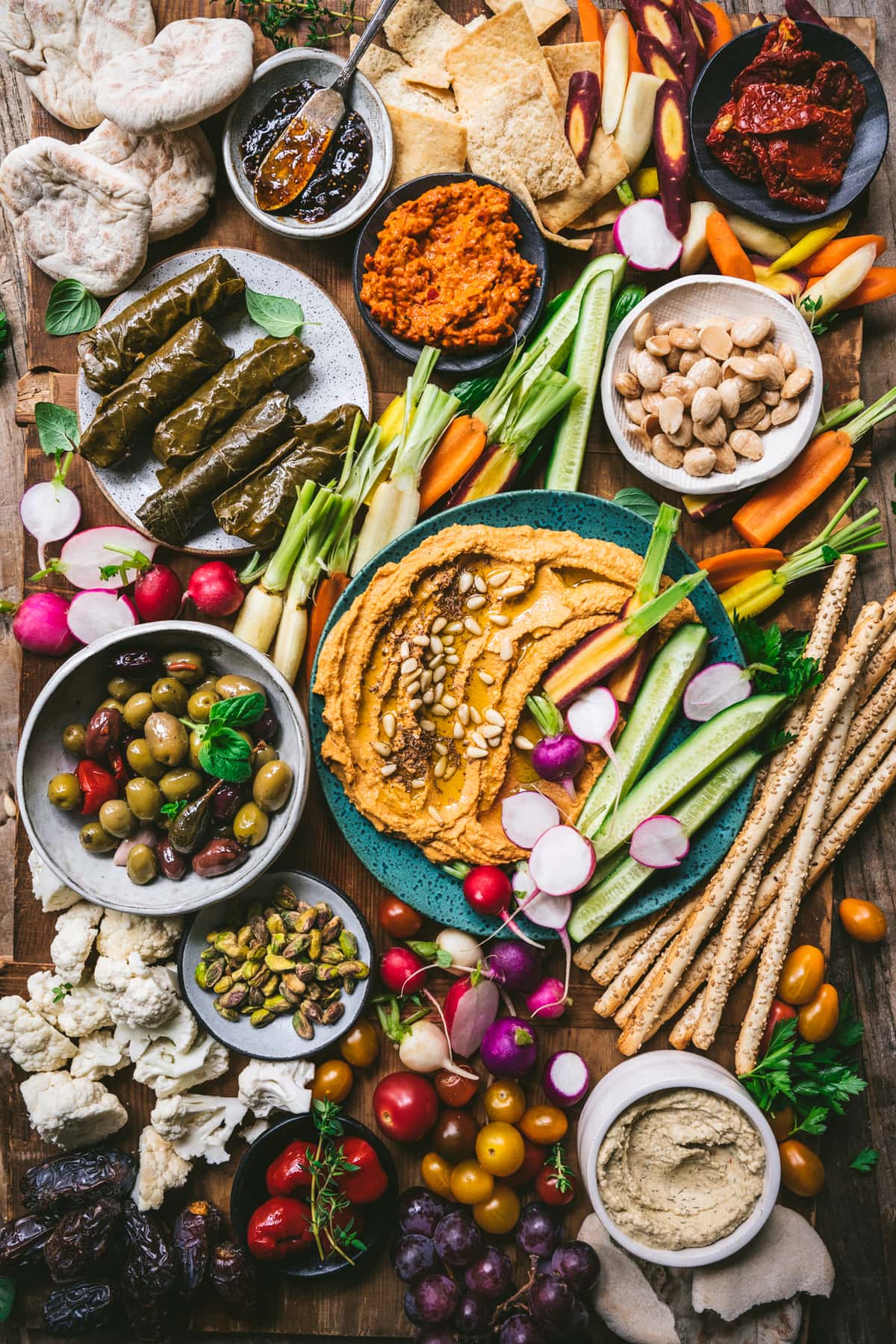 overhead view of Vegan Mezze Platter with hummus, dolma, nuts, vegetables and more