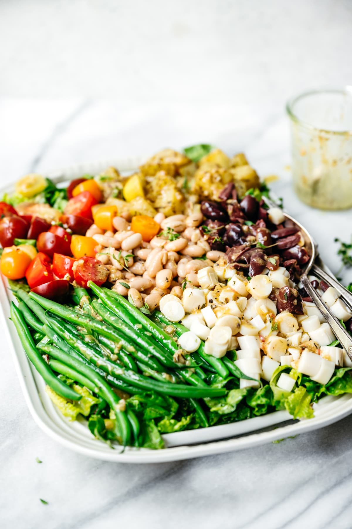 side view of vegan nicoise salad on a platter