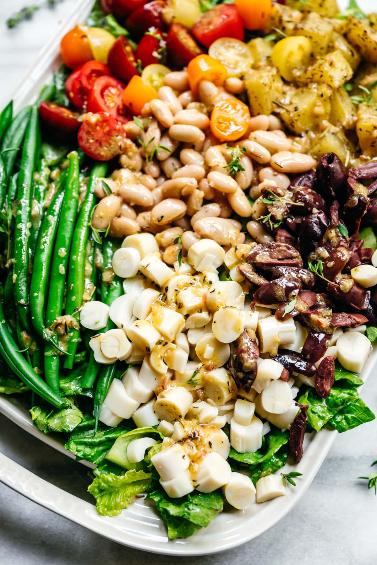 close up view of vegan nicoise salad with white beans and hearts of palm