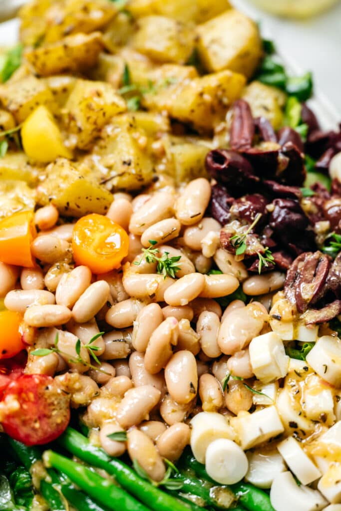 close up of white beans in a vegan nicoise salad