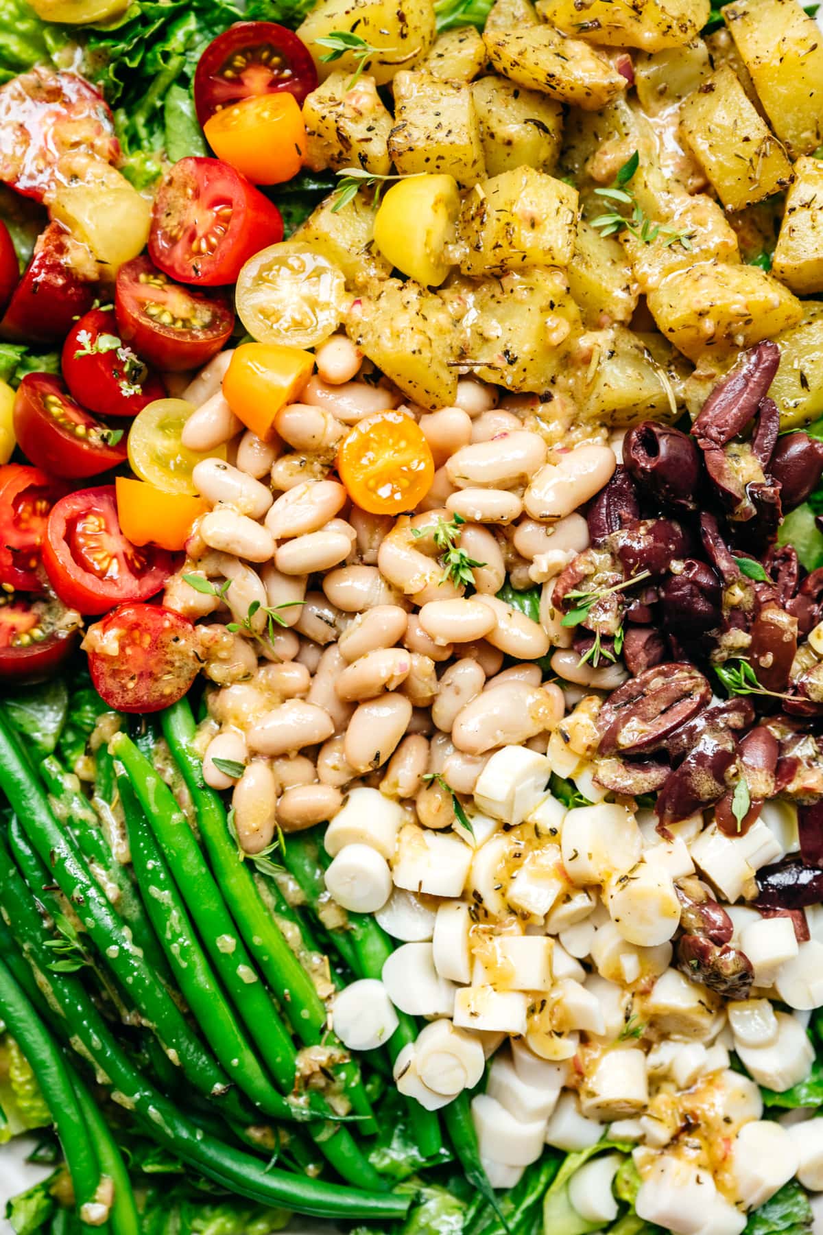 close up view of vegan nicoise salad with white beans and hearts of palm