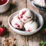 Strawberry ice cream in a bowl from above.