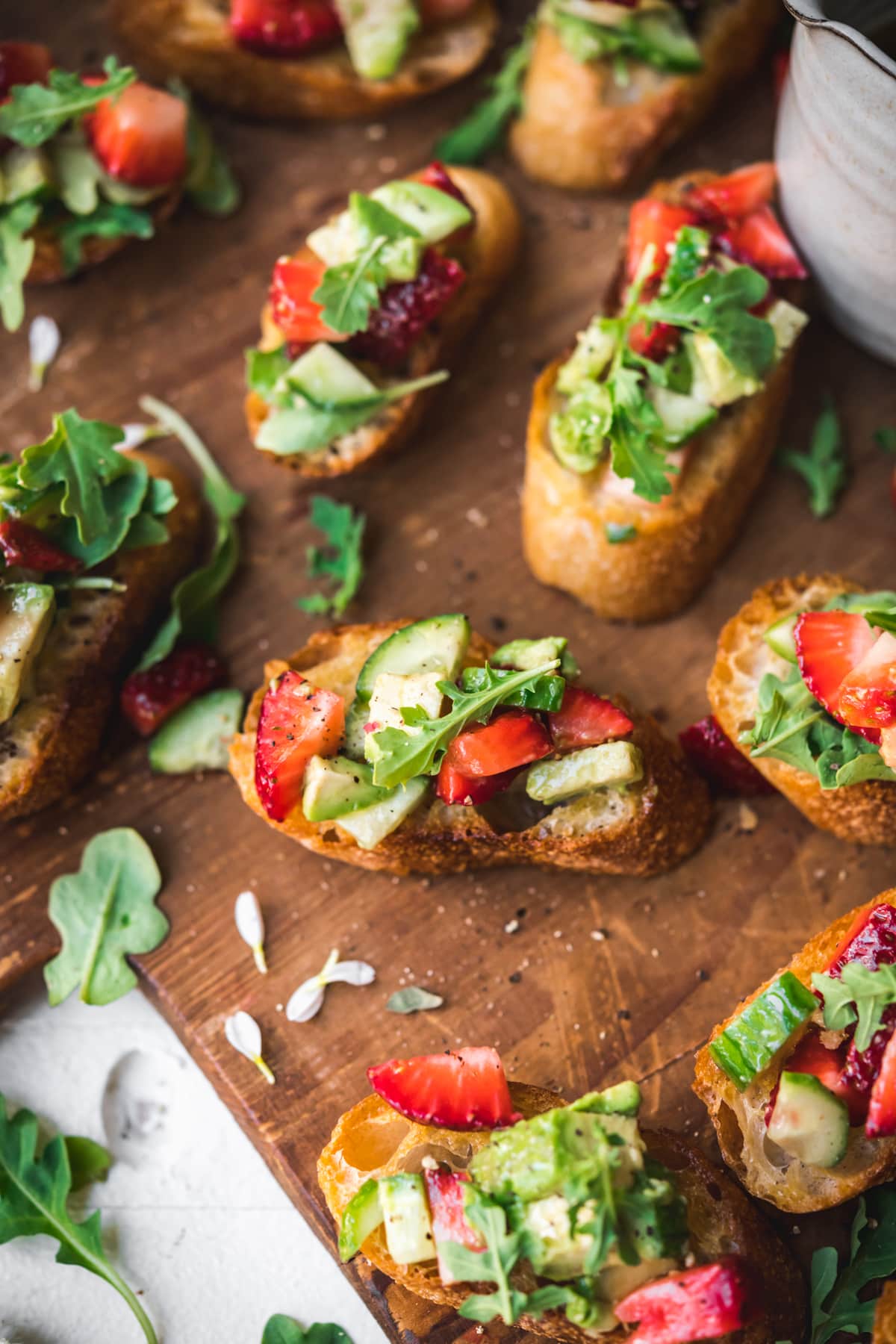 close up view of crostini topped with strawberry avocado salsa