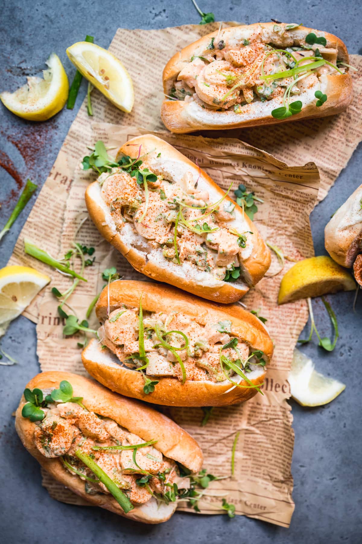 overhead view of vegan lobster rolls on newspaper