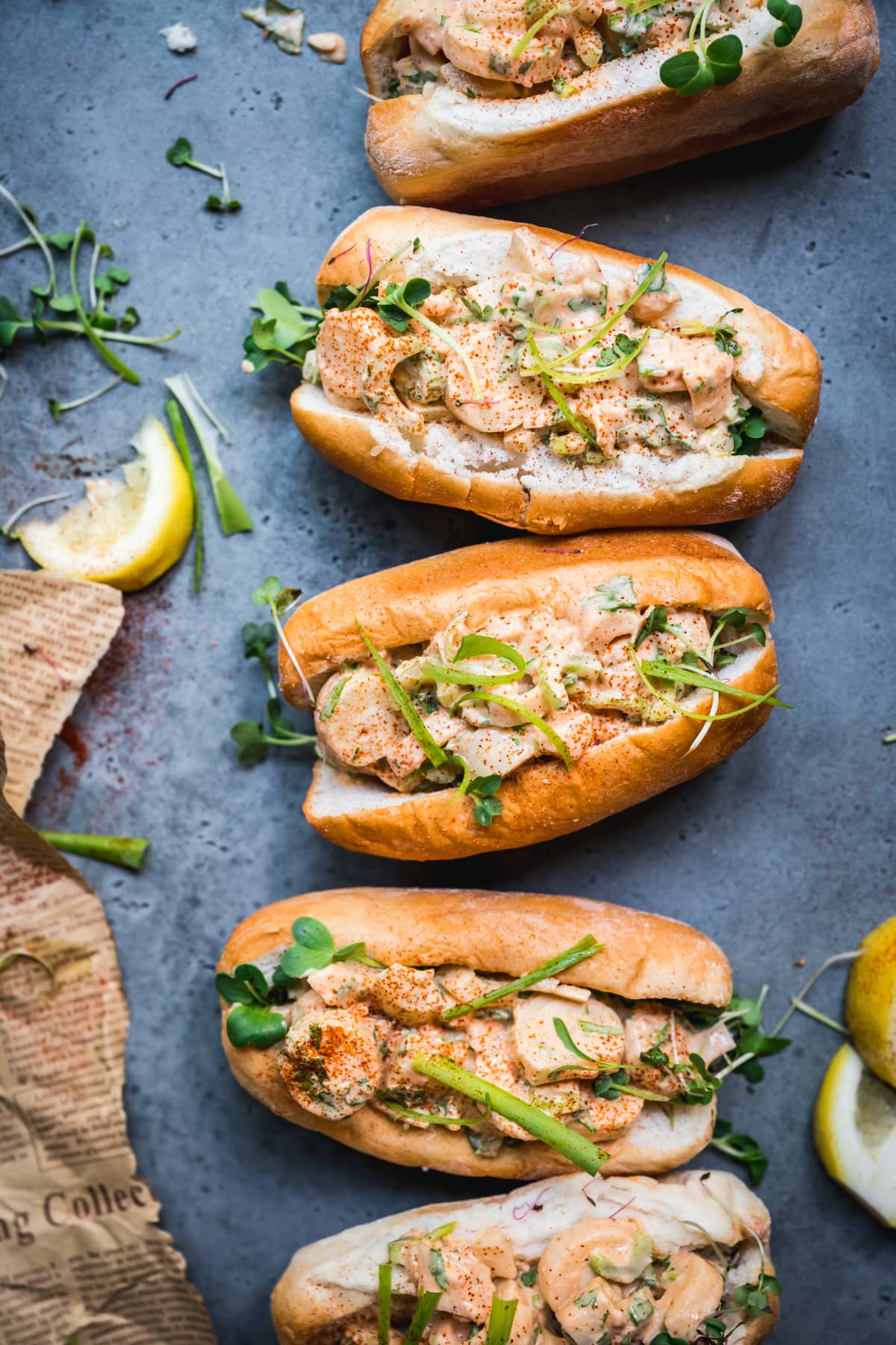 overhead view of vegan lobster rolls on blue background