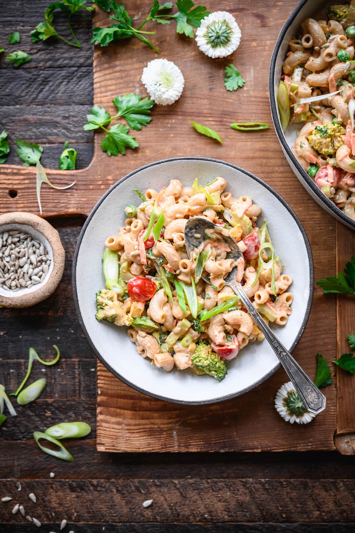 overhead view of vegan macaroni salad in a bowl with fresh vegetables