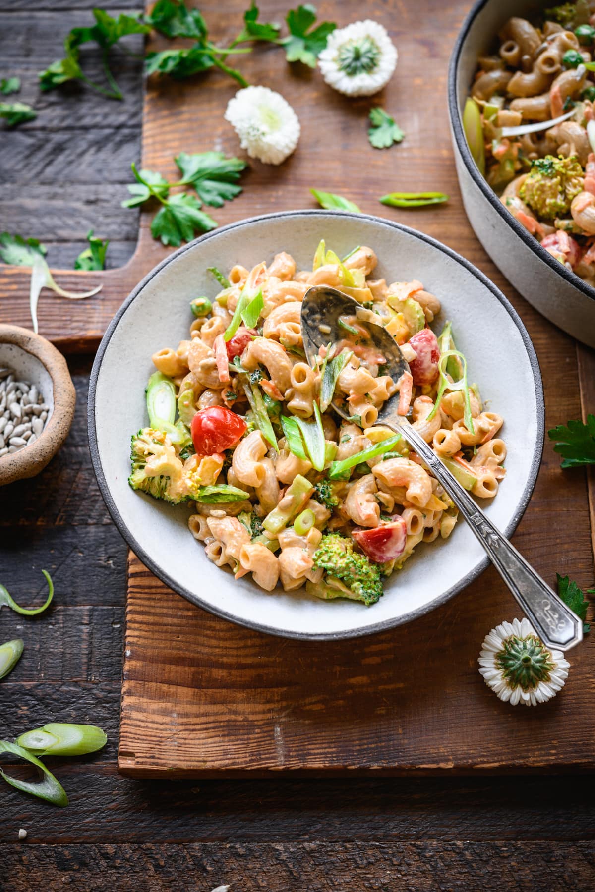 overhead view of vegan macaroni salad in a bowl with fresh vegetables