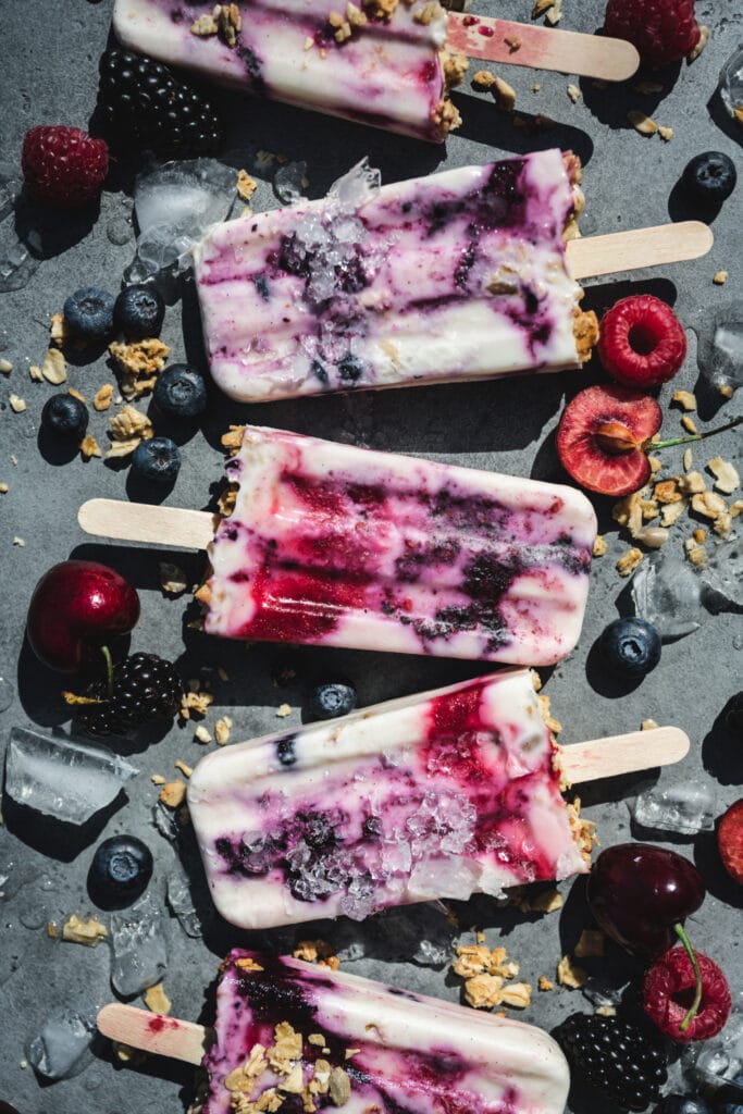 overhead view of vegan yogurt berry breakfast popsicles with berries
