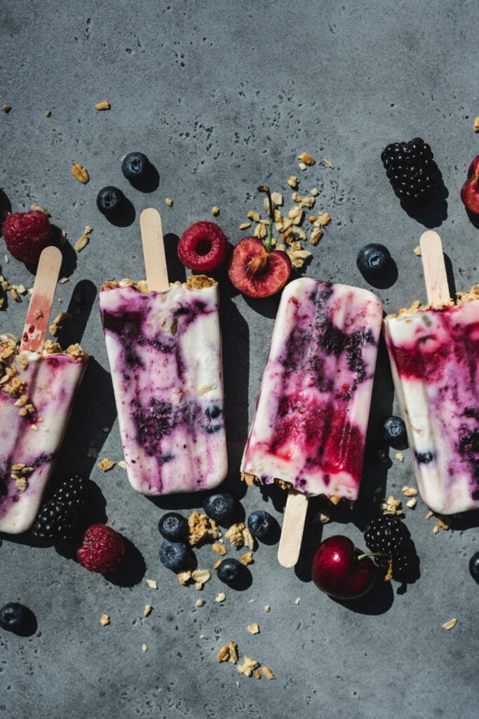 overhead view of vegan yogurt berry breakfast popsicles with berries