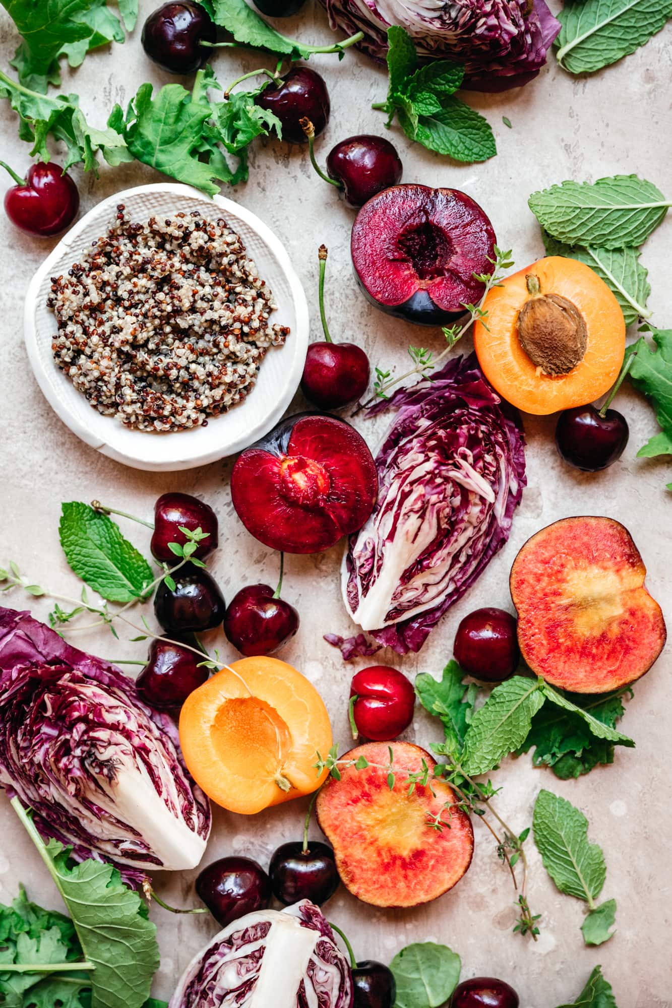 overhead view of stone fruit salad ingredients with quinoa