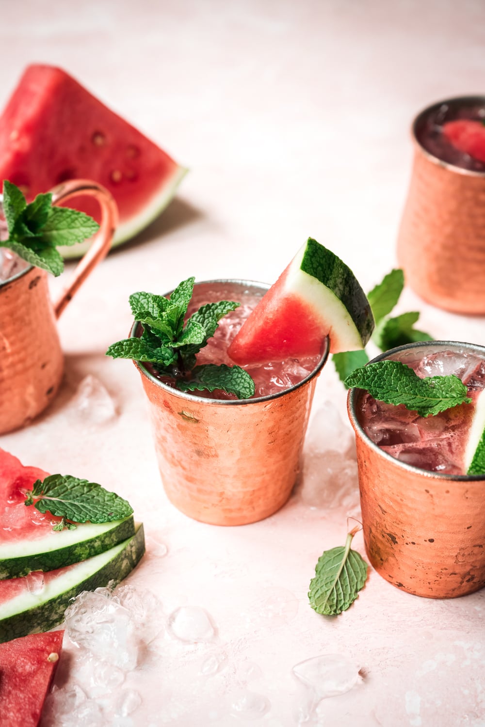 side view of watermelon moscow mule in copper mug with mint garnish