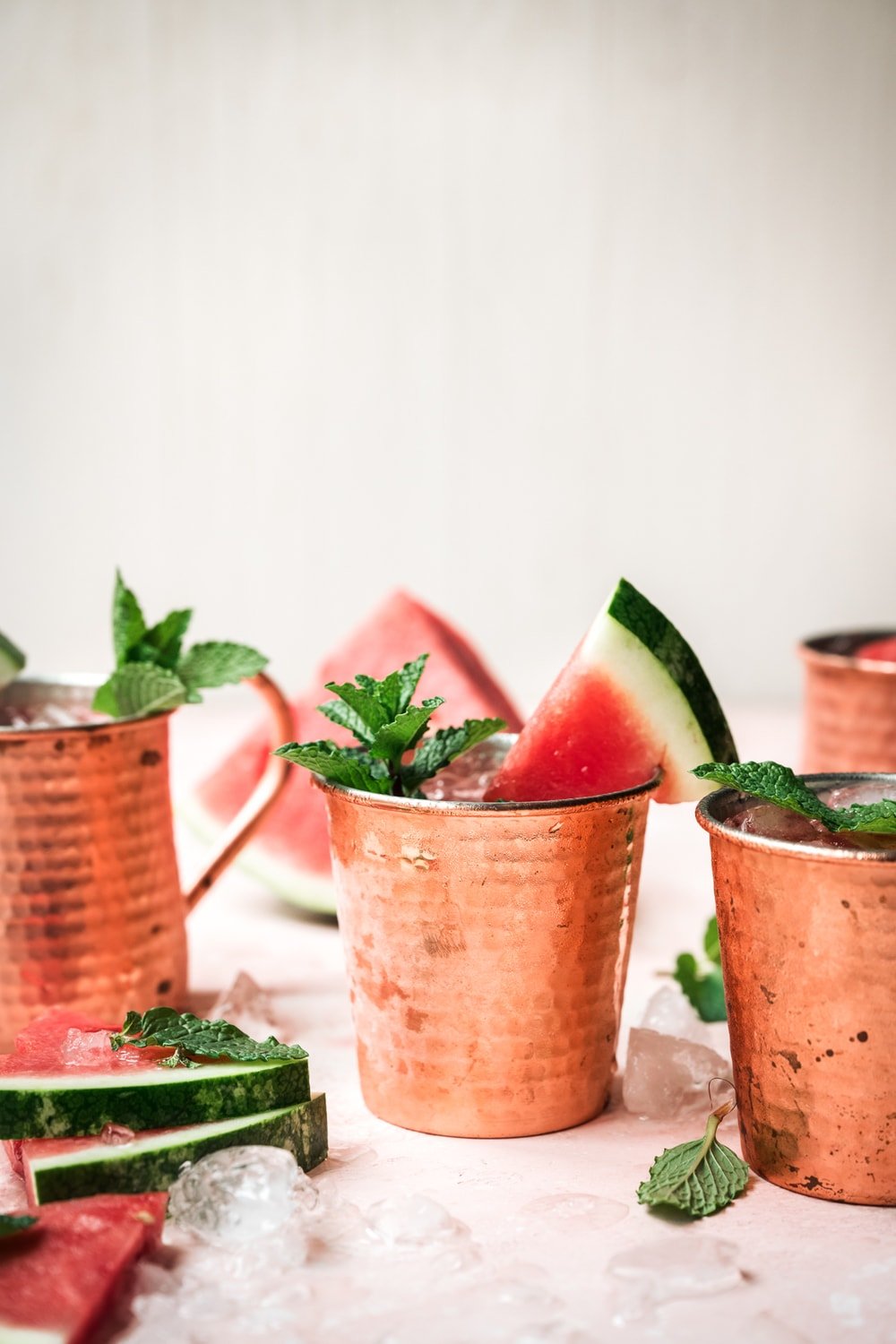 side view of watermelon moscow mule in copper mug with mint garnish
