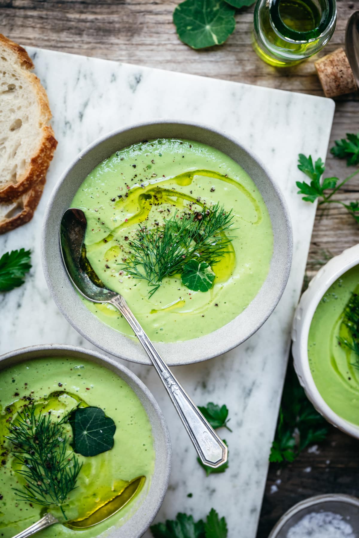 overhead view of vegan cucumber avocado gazpacho in bowls