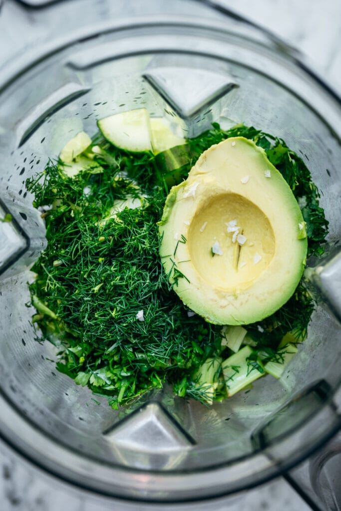 overhead view of cucumber avocado gazpacho ingredients in blender
