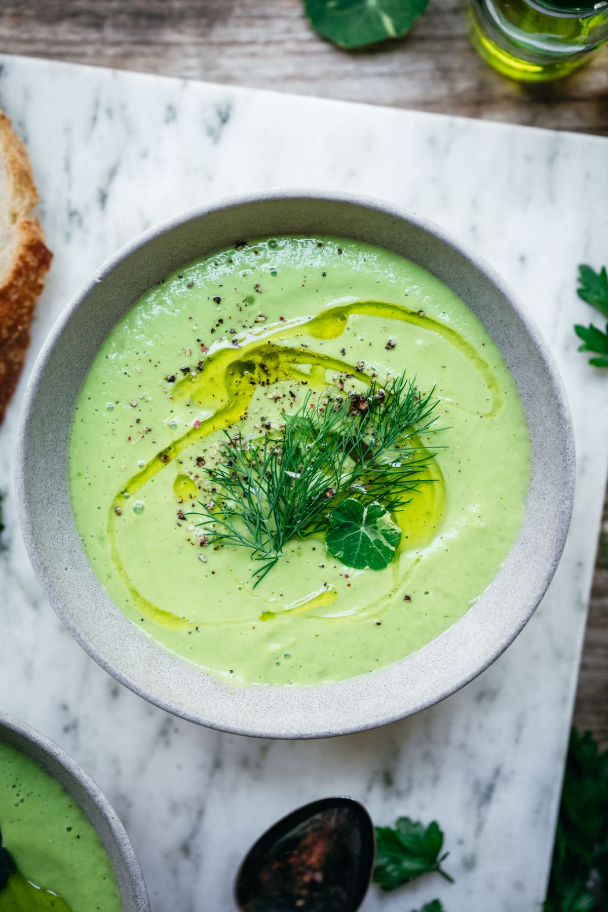 close up overhead view of cucumber avocado gazpacho in bowl