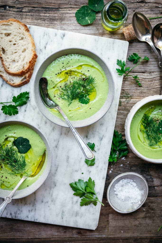 overhead view of vegan cucumber avocado gazpacho in bowls