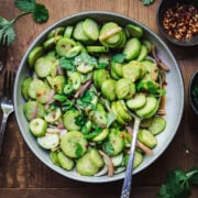 overhead view of Sweet & Spicy Cucumber Salad in bowl with serving spoon