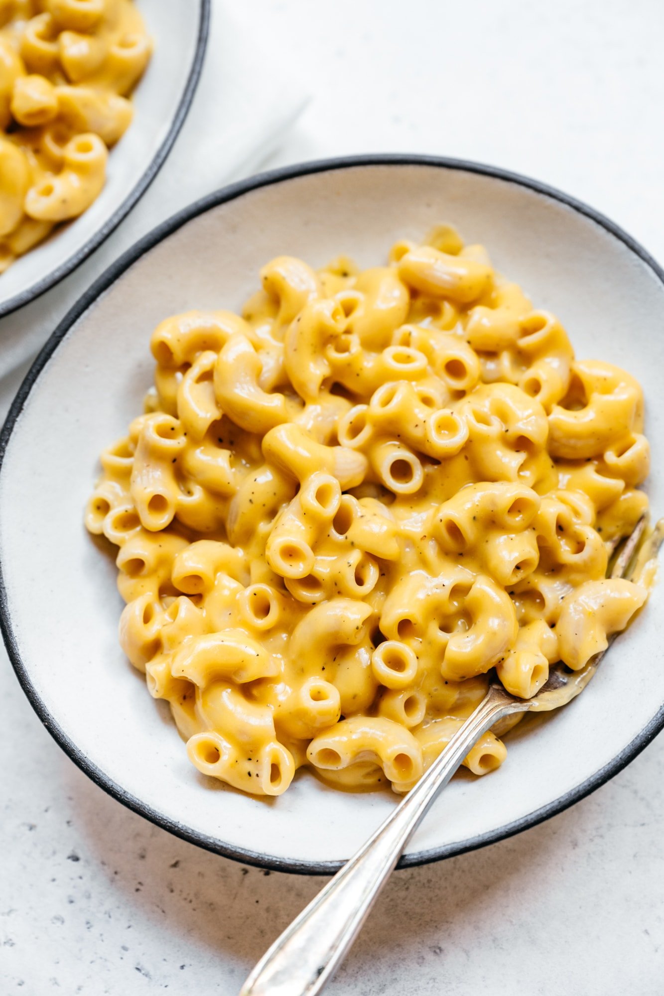 close up view of vegan mac and cheese in white bowl