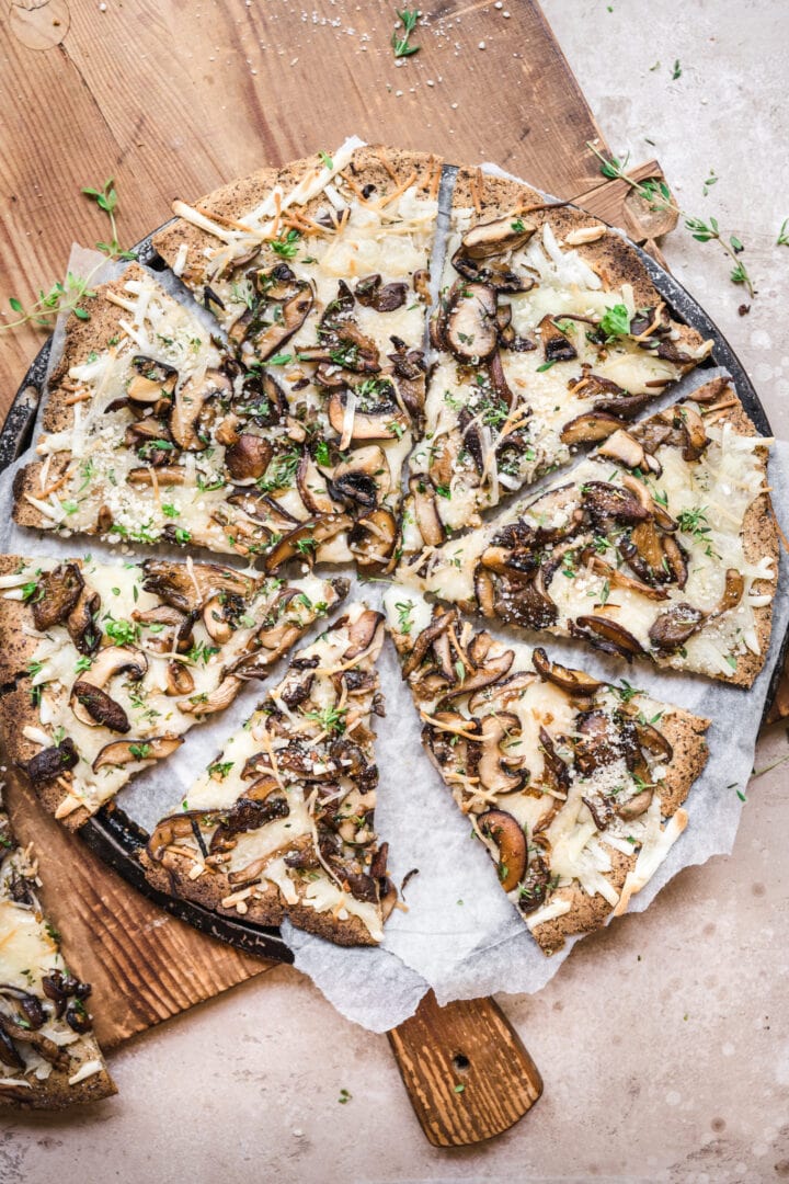 overhead view of mushroom pizza cut into slices