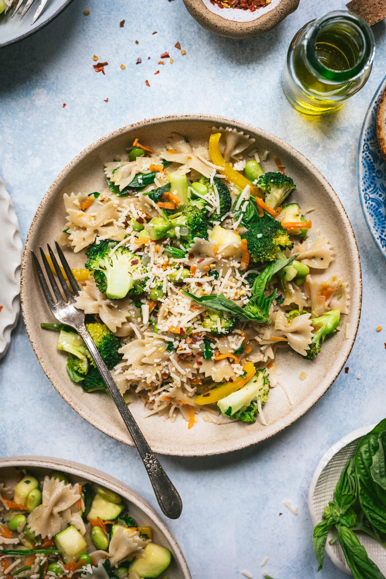 overhead view of vegan pasta primavera in a bowl with fork 