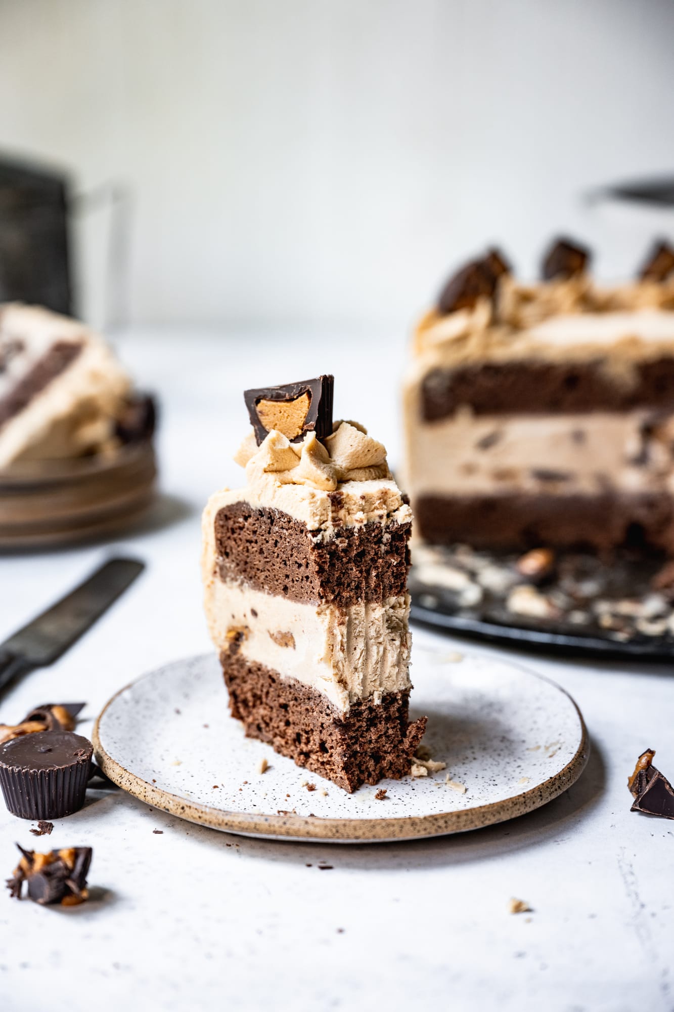 side view of slice of chocolate peanut butter ice cream cake with bite taken out