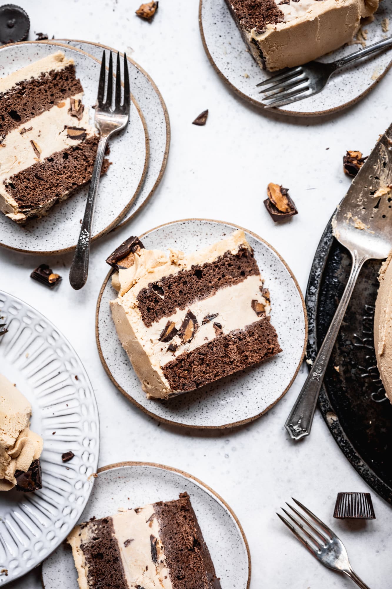 overhead view of chocolate peanut butter ice cream cake slices on white plates